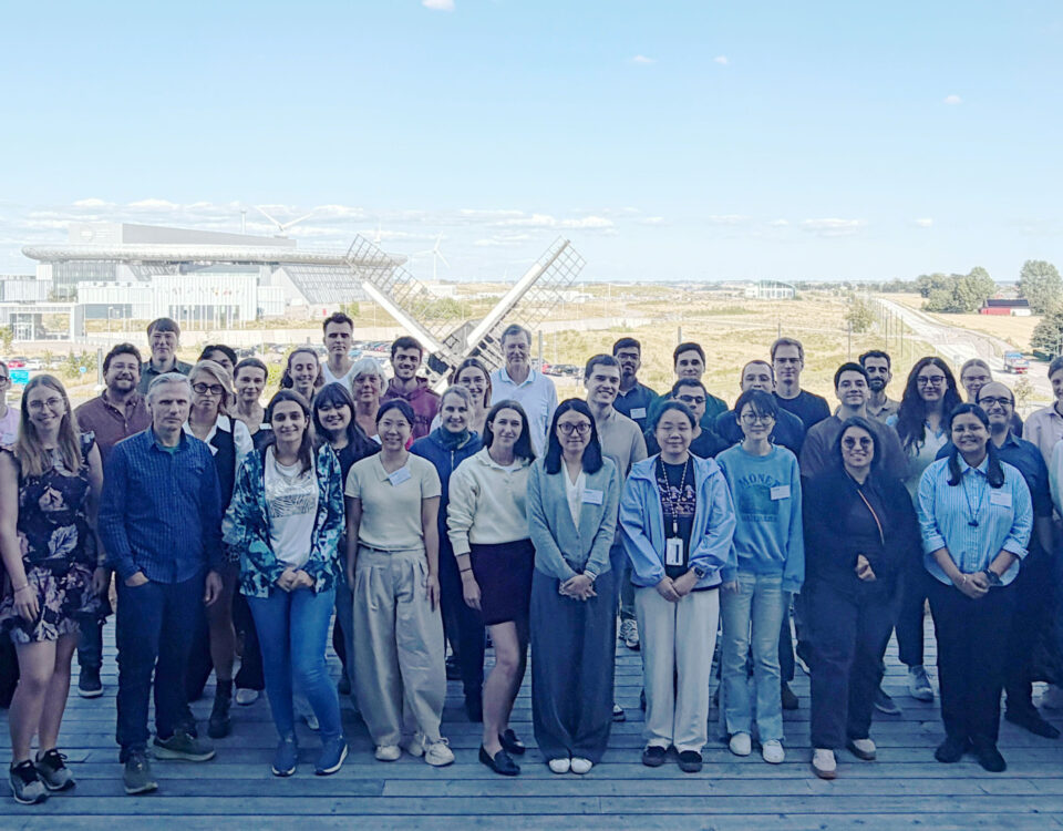 Participants and lecturers of the COMMONS/LINXS/SoftComp PhD Summer School LLPS2026 on the LINXS balcony in Lund, Sweden, August 2026, with the European Spallation Source (ESS) visible in the background. Copyright: LINXS/Mia Lindström
